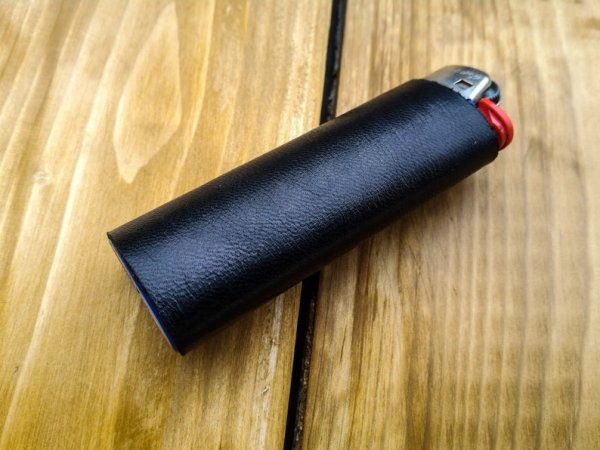 Refillable lighter with black leather sleeve